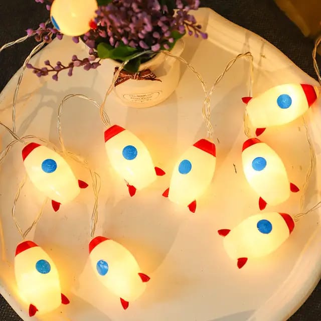 "LED Rocket String Lights featuring 10 rocket-shaped LED lights, USB & battery operated, perfect for room décor, parties, and children's rooms. Creative and fun lighting for any space."