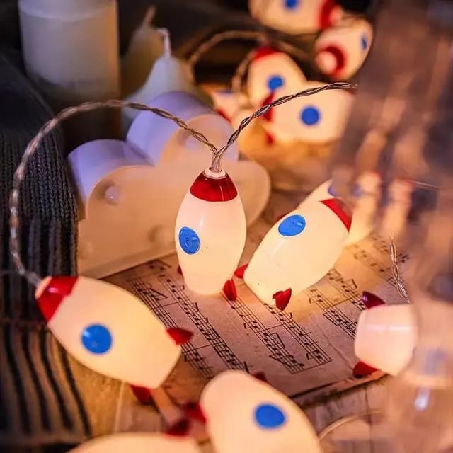 "LED Rocket String Lights featuring 10 rocket-shaped LED lights, USB & battery operated, perfect for room décor, parties, and children's rooms. Creative and fun lighting for any space."