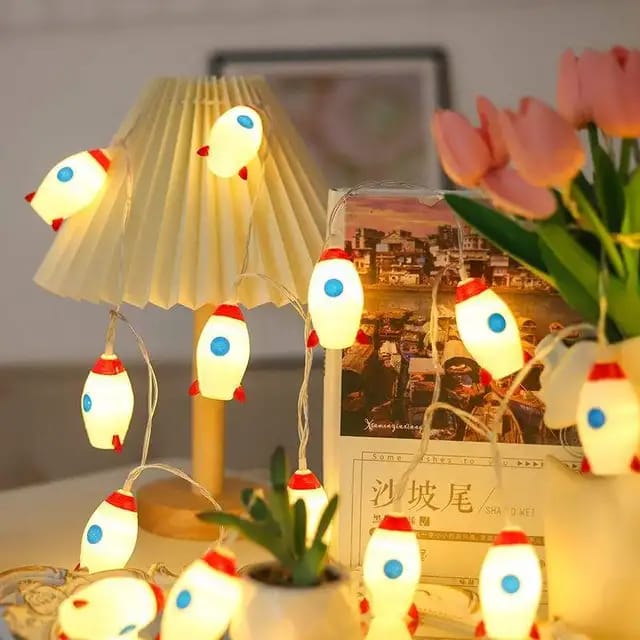 "LED Rocket String Lights featuring 10 rocket-shaped LED lights, USB & battery operated, perfect for room décor, parties, and children's rooms. Creative and fun lighting for any space."