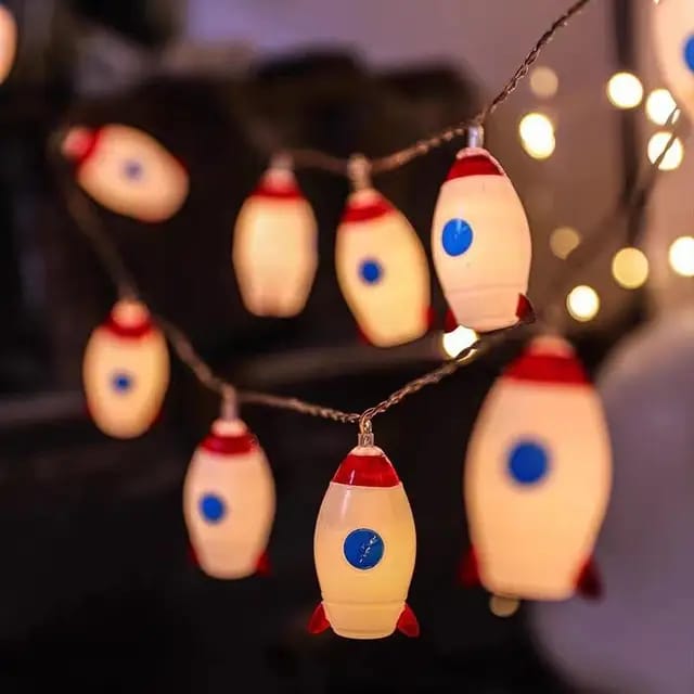 "LED Rocket String Lights featuring 10 rocket-shaped LED lights, USB & battery operated, perfect for room décor, parties, and children's rooms. Creative and fun lighting for any space."