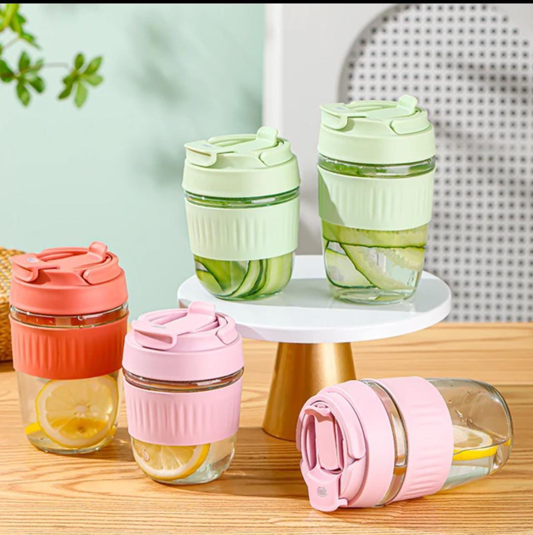 "Portable glass mug with built-in straw, perfect for sipping coffee, tea, and juice on-the-go."